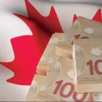 Canadian dollar banknote bundles on textile textured Canada flag. 3d rendered illustration.