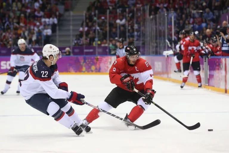 Feb 21, 2014; Sochi, RUSSIA; Canada forward Sidney Crosby (87) and USA defenseman Kevin Shattenkirk (22) battle for the puck in the men's ice hockey semifinals during the Sochi 2014 Olympic Winter Games at Bolshoy Ice Dome. Mandatory Credit: Winslow Townson-USA TODAY Sports